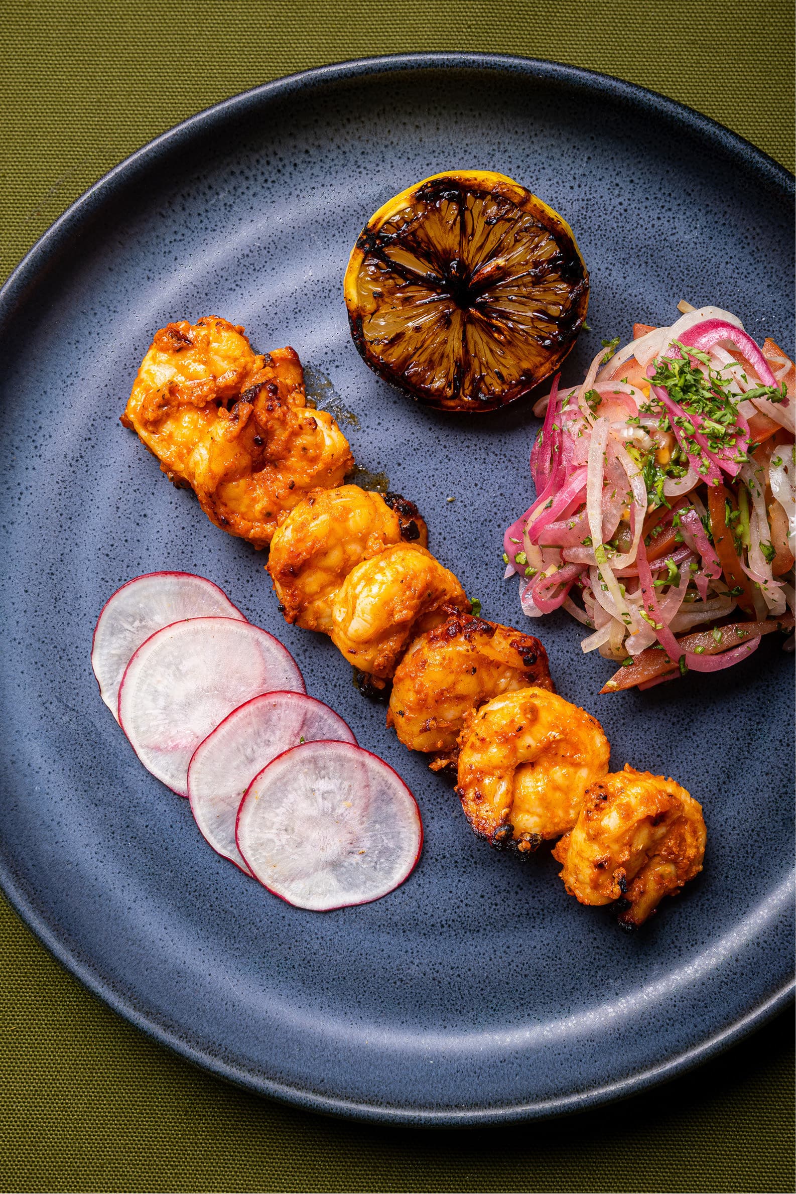 Chicken skewer with radish and charred lemon